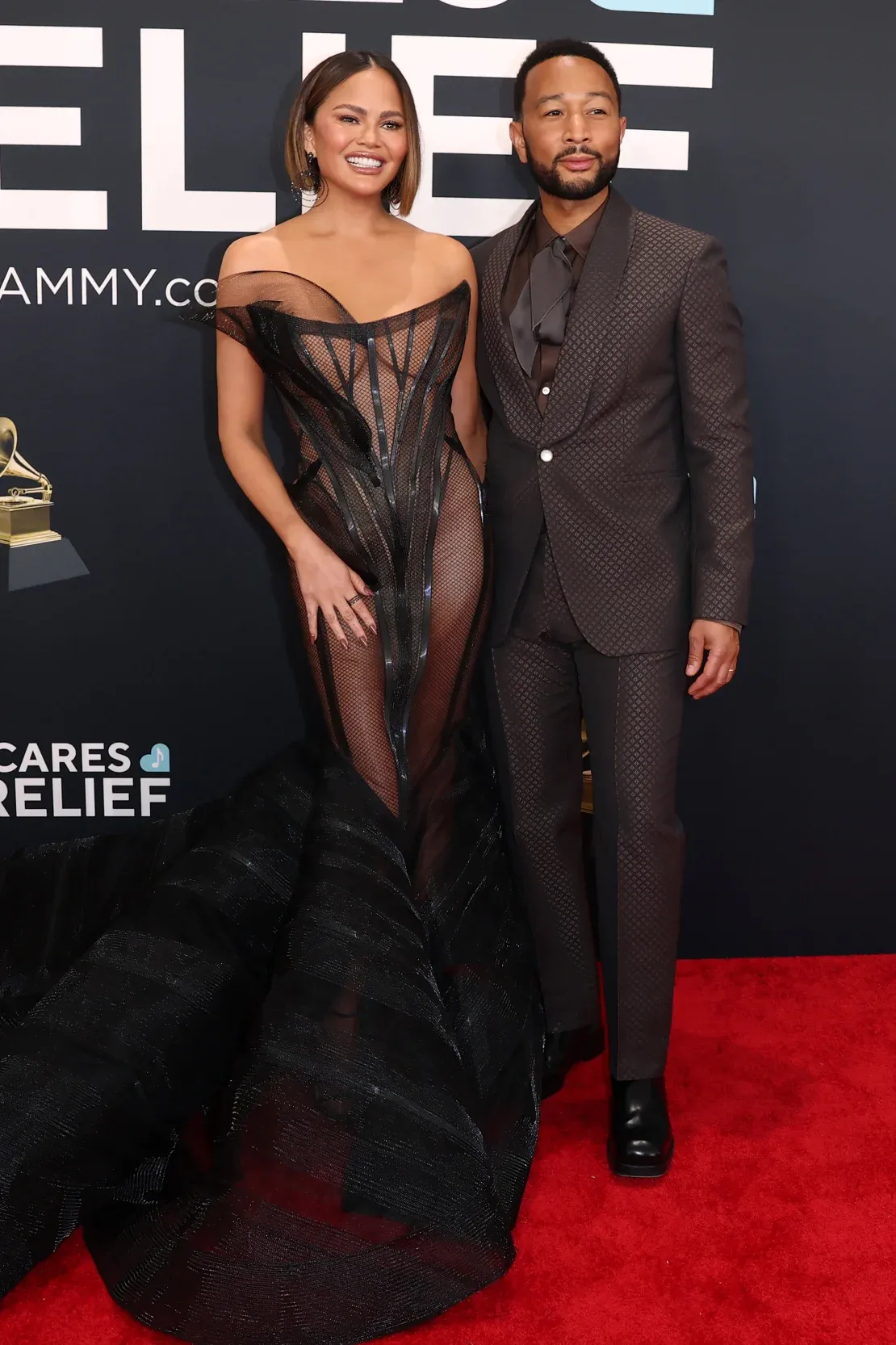 Chrissy Teigen in Siriano and John Legend in Vuitton